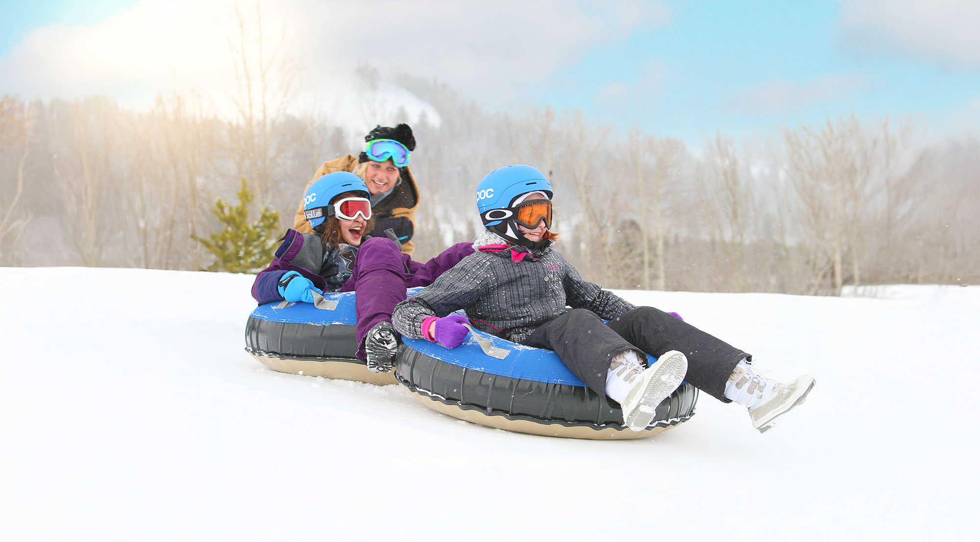 kids in snow tubes ready to slide down the hill