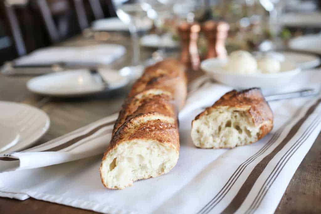 C Lazy U bread sits on a table ready to eat next to some butter