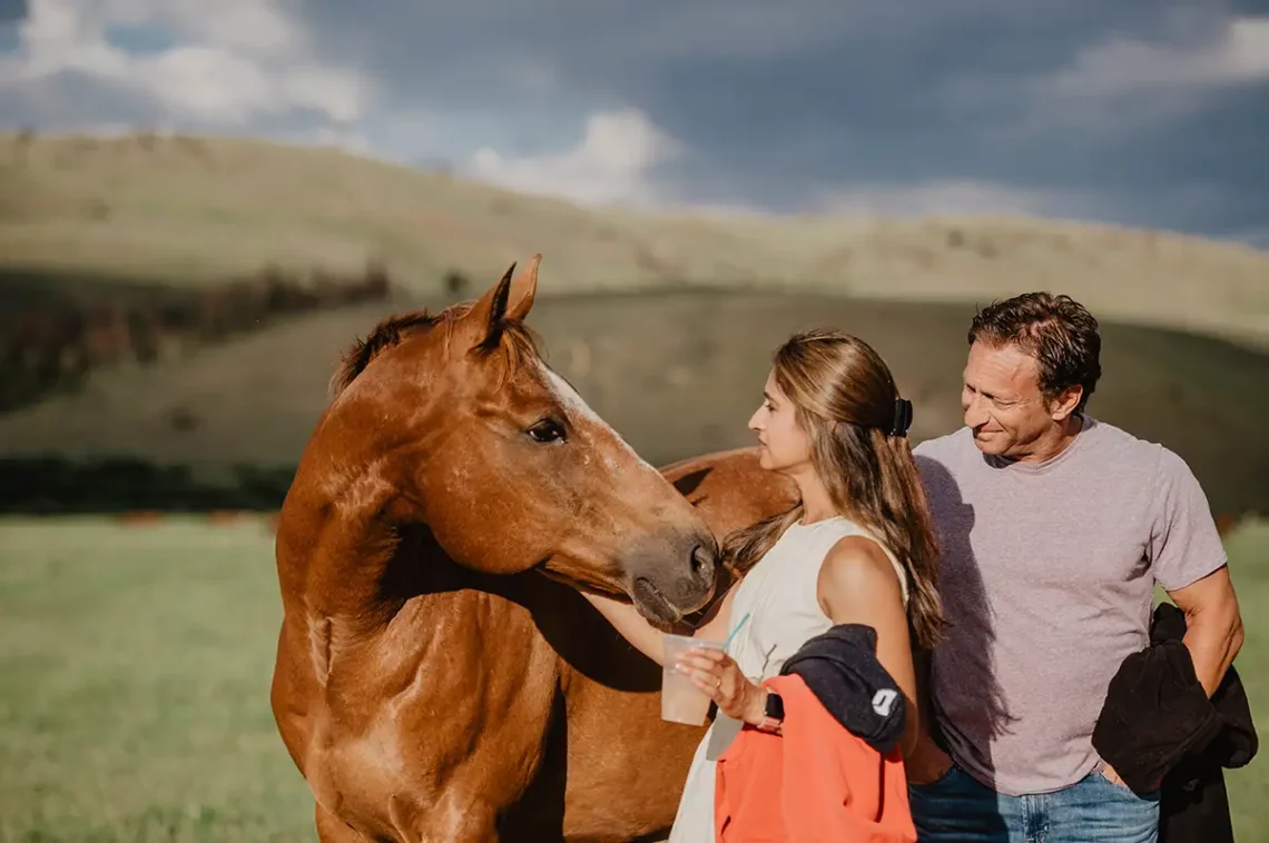 A woman and horse smile at each other