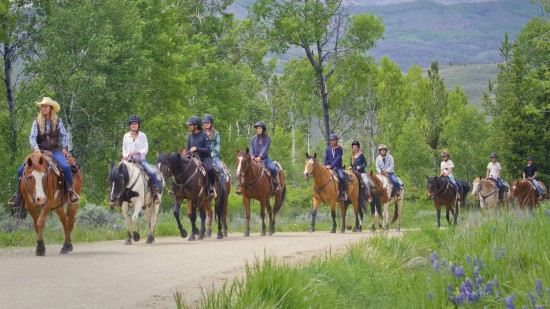 teens riding the trails at C Lazy U in the summer