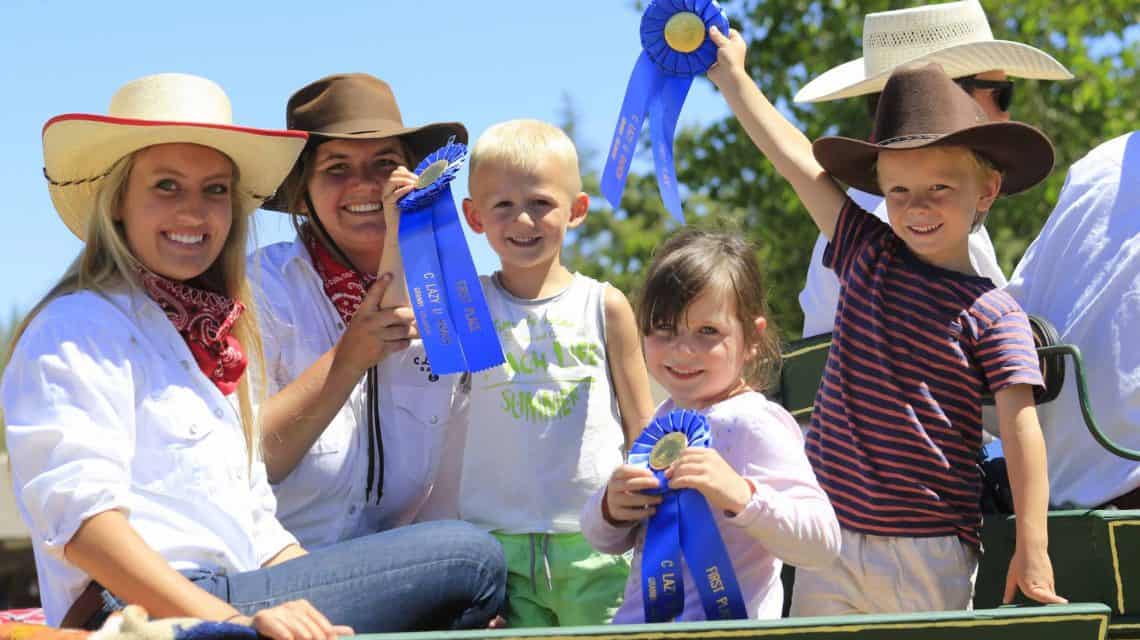 kids show off the ribbons they won during their vacation at C Lazy U