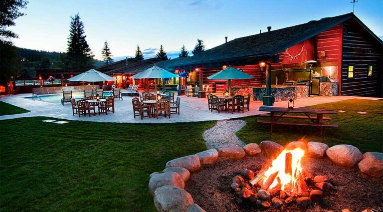 A campfire lit outside the Patio House at dusk