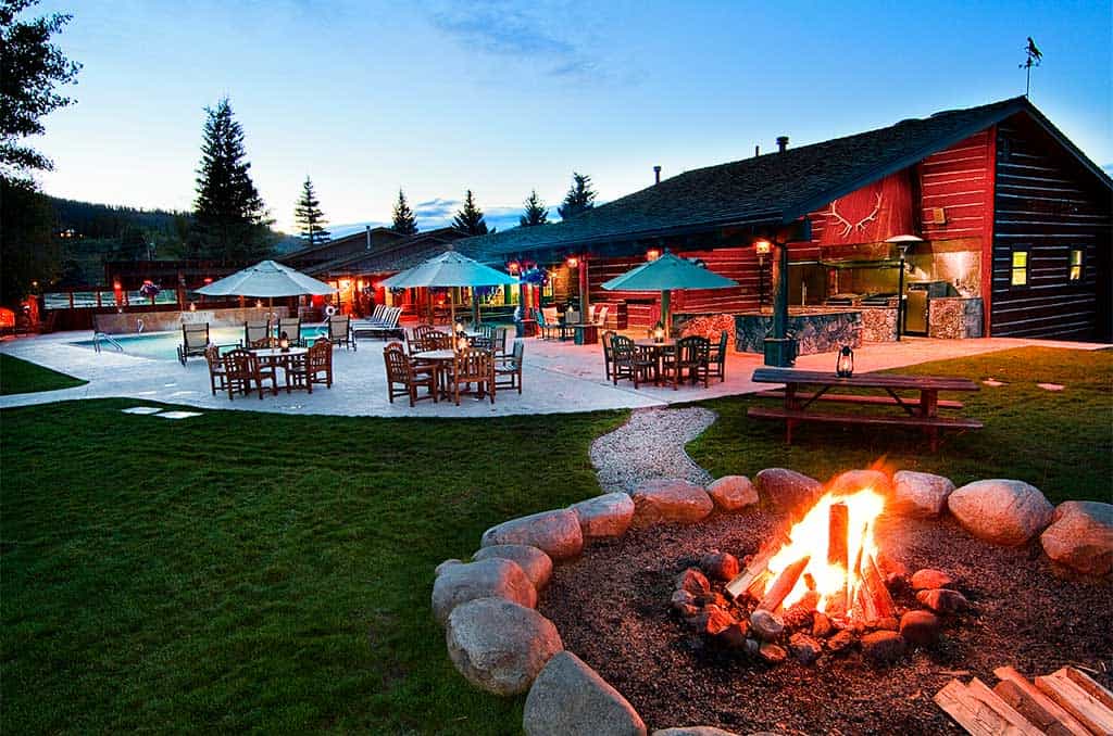 A campfire lit outside the Patio House at dusk