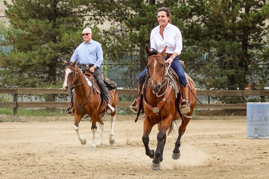 a man and women race their horses to the finish line in the C Lazy U Shodeo