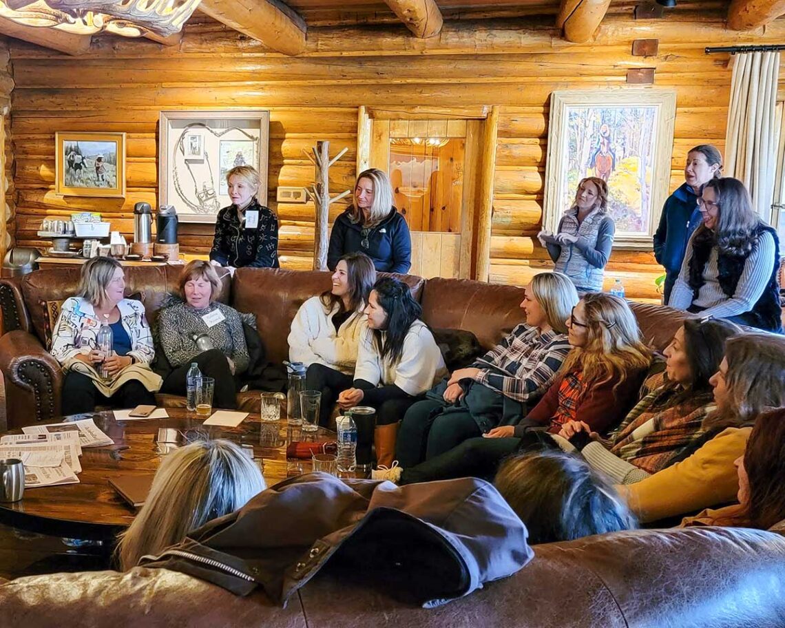 women gathered in the main lodge's great room for and evening Q & A session