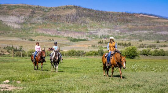 wrangler-leading-teens-across-meadow