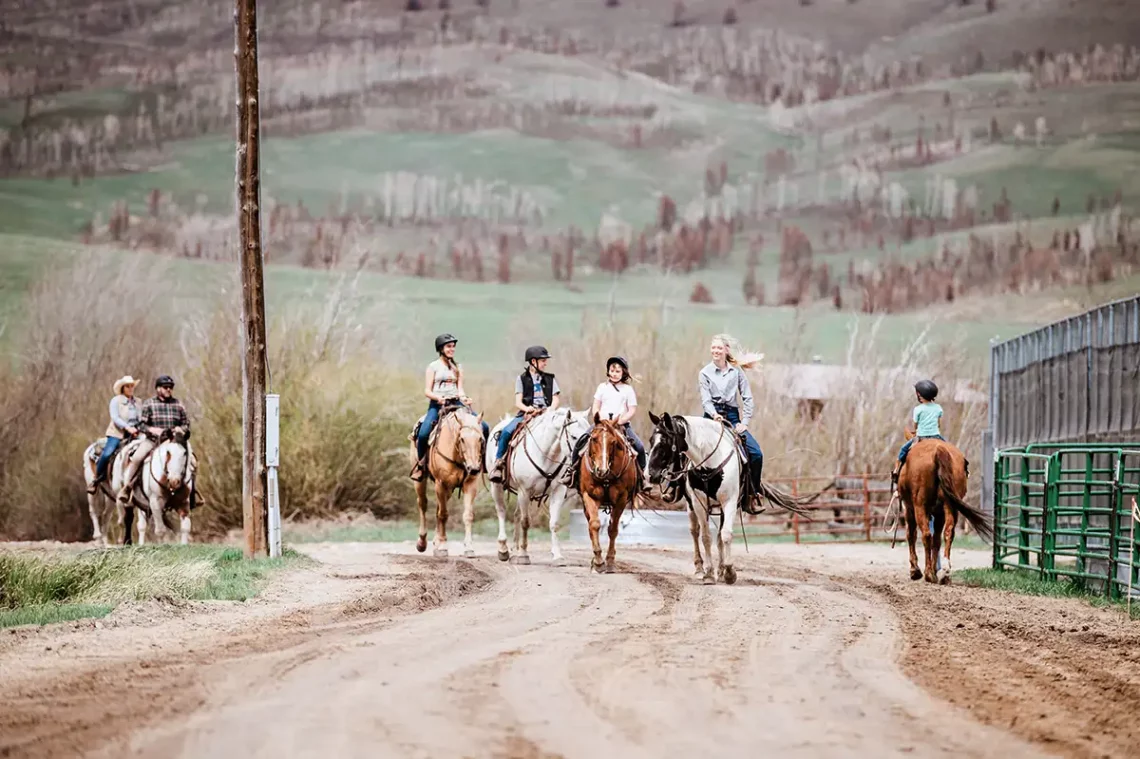 A family coming back from a trail ride at C Lazy U Ranch