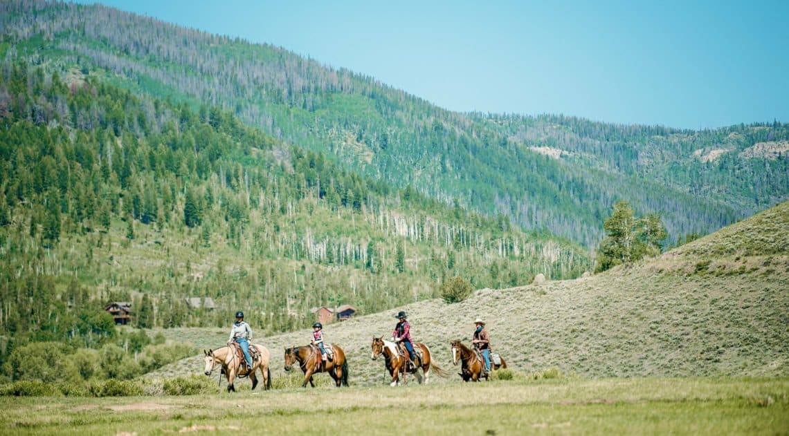 Trail ride under blue skies at C Lazy U Ranch