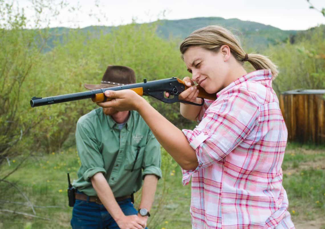 a woman shooting a BB gun