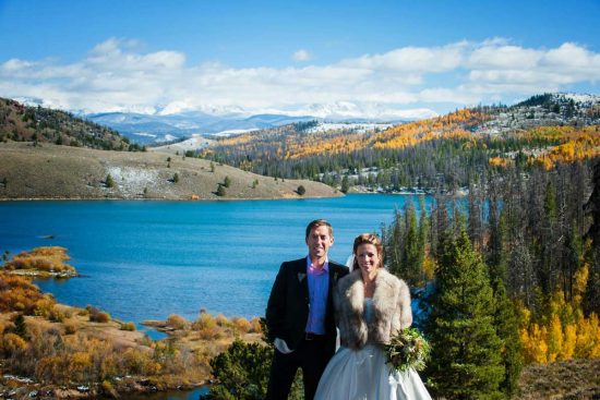 Bride and groom posing by water